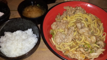 Pork and noodle dish with rice and a miso soup.